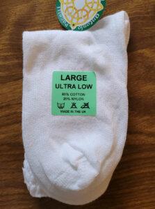 A pair of pacelli ultra low poodle socks with a green sticker