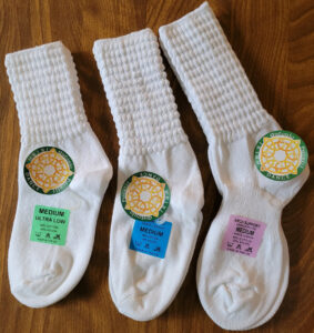 Three pairs of pacelli poodle socks, showing the three varieties